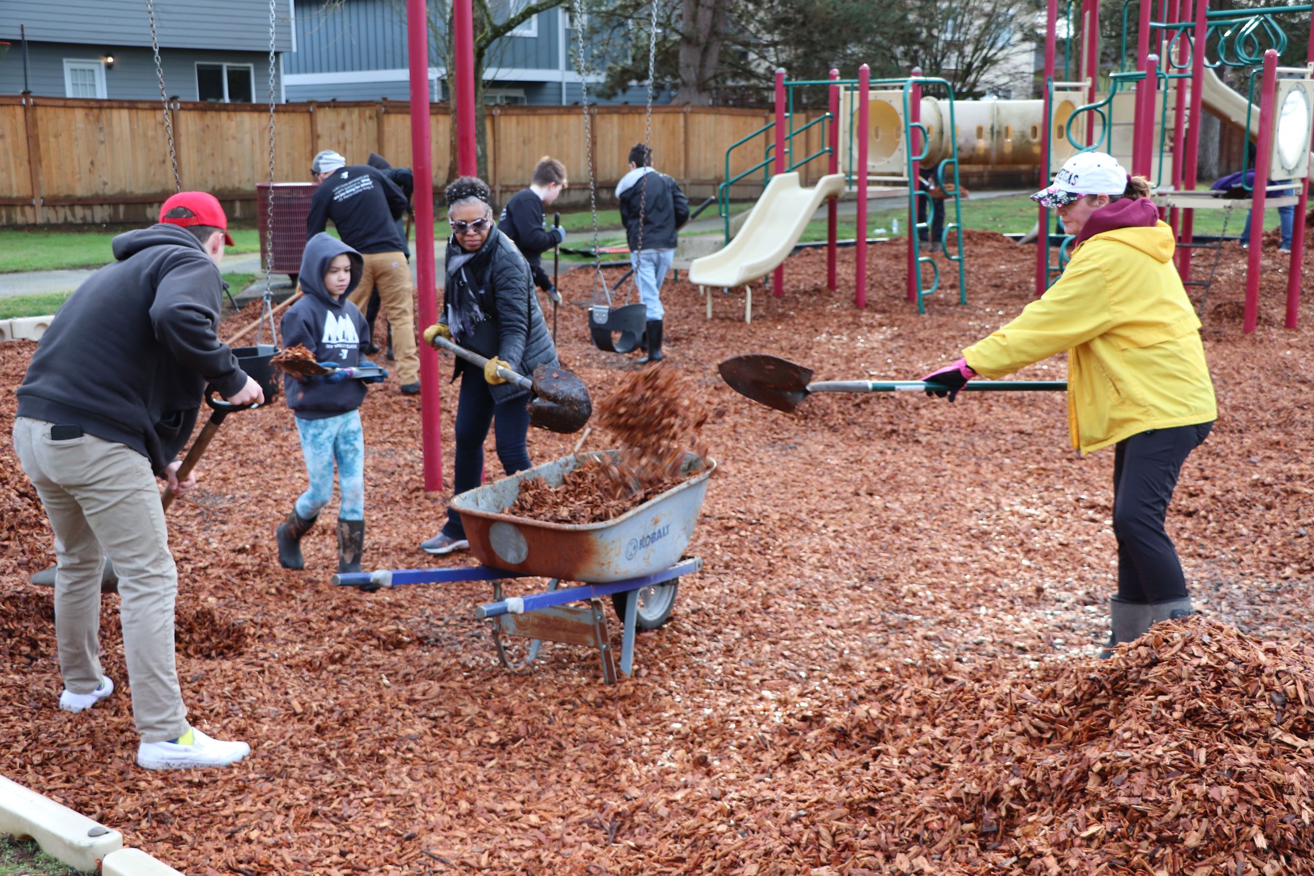 An image of community members spreading play chips at a park in Monroe.